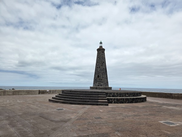 Torre in pietra vulcanica a forma di faro sul lungomare di Bajamar.